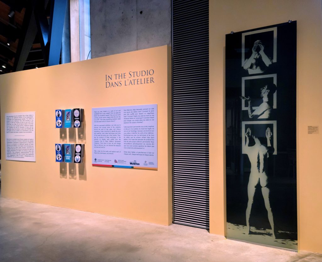 An image of the front of the 'In the Studio' display, featuring brochures and a glass panel.